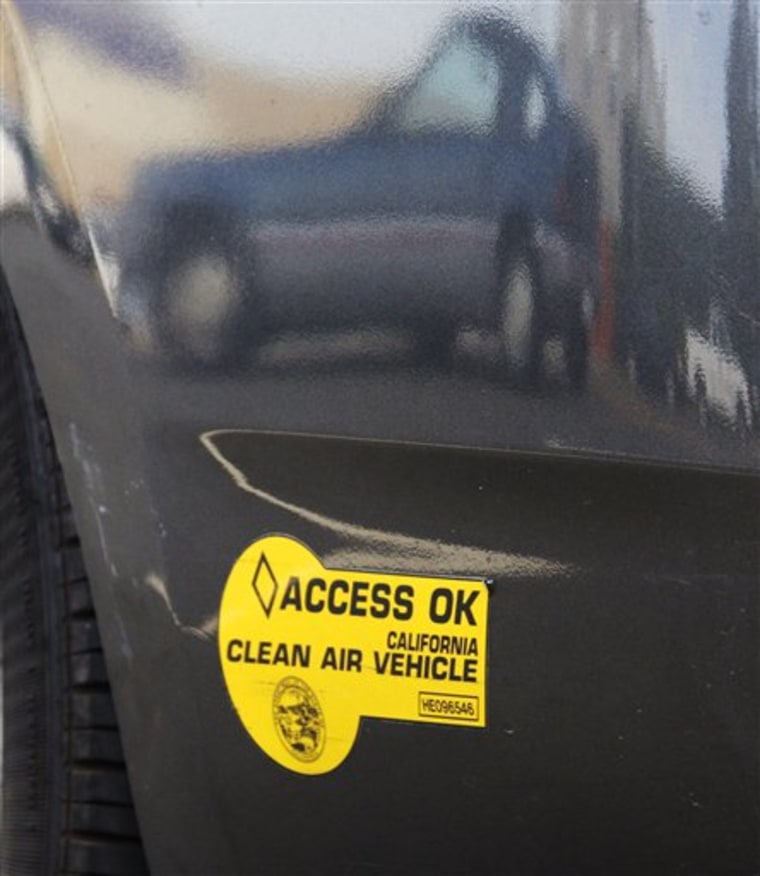 In a June 28, 2011 photo, other autos are reflected in the curved bumper of a Toyota Prius hybrid auto bearing California DMV decals in Los Angeles. The program that allowed single occupants of hybrids to use carpool lanes expires at the end of June. (AP Photo/Reed Saxon)